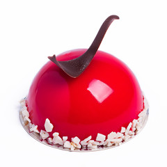 French mousse cake covered with cherry glaze isolated on white. Modern American dessert