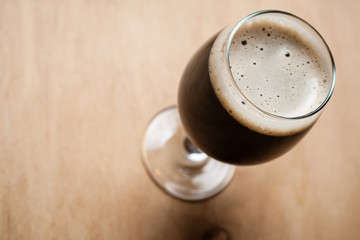 Glass of stout on wood