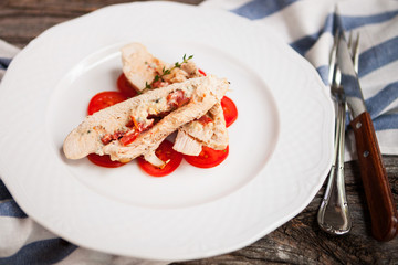 Chicken with cheese Dorblu and tomatoes, served rosemary on vint