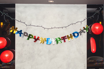 Happy birthday greeting on the wall at children birthday party.