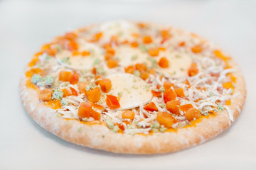 Frozen pizza on baking paper