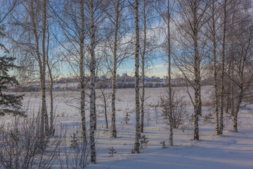 Church on the hill behind the snow field