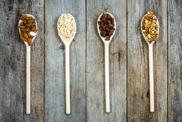 Ingredients of muesli for breakfast, healthy diet rich in fiber: oats, raisins, almond and nuts