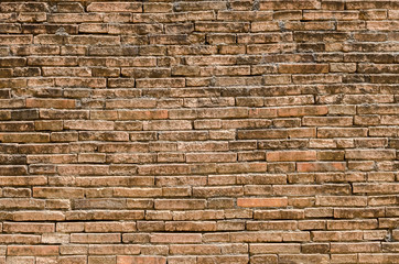 Old grunge brown stone brick wall texture abstract background.