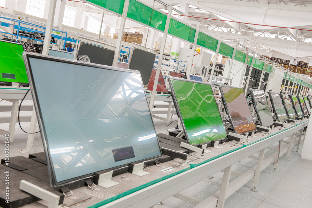 Wall mural closeup line conveyor assembly and testing televisions in a workshop