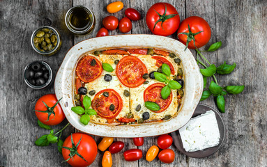 Feta baked with tomatoes. Greek food of mediterranean diet. Vegetarian dish for healthy eating.