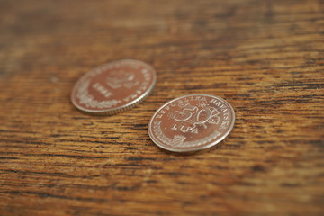 Macro detail of Croatian coins (Kuna and Lipa, HRK) on the wooden desk as a financial background of...