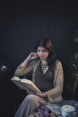 Girl reading a book in a coffee shop
