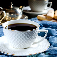 Tea in a white Cup. A dark photo.