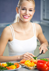 woman making salad at domestic kitchen