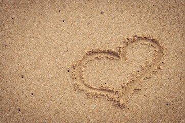 Heart drawing on sand beach