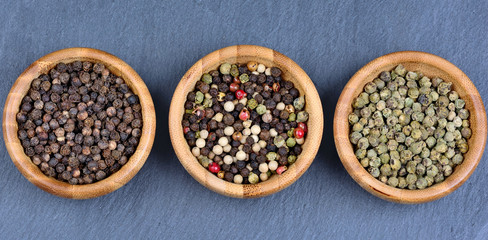 Different peppercorns in a bowls