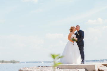 Fototapeta premium bride and groom on the background of the river