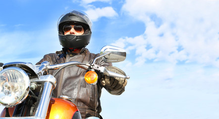 Biker On the road over blue sky