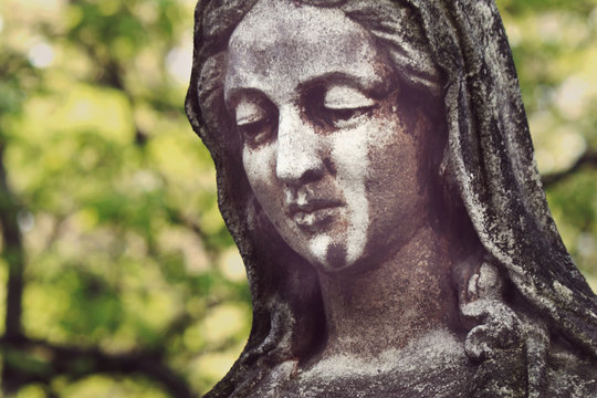 Statue of Virgin Mary in tears (sadness, regret, fear, religion)