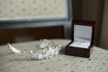 wedding rings in a brown box and a crown