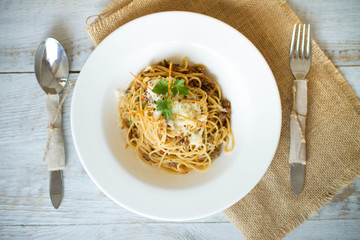 Spaghetti with tomato paste, hot Chili peppers and olive oil. On rustic background. Top view