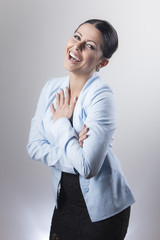 Happy businesswoman laughing sincerely, young caucasian person dressed in blue suit