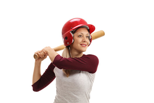 Female baseball player with a wooden bat ready to strike - Powered by Adobe