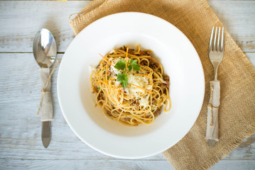 Spaghetti with tomato paste, hot Chili peppers and olive oil. On rustic background. Top view