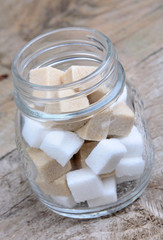 Sugar cubes in a jar on table