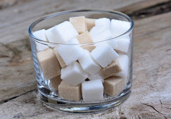 Sugar cubes in a glass on table