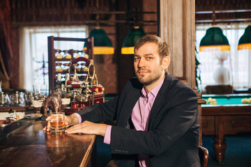 young man talking to a bartender in the bar