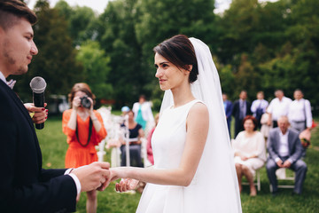 The groom wear a wedding ring for bride
