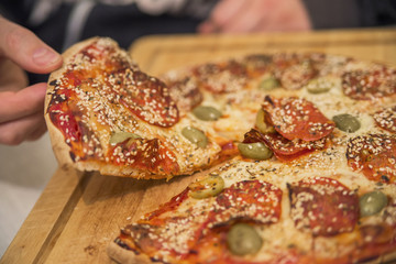 Eating Food. Close-up Of People Hands Taking Slices Of Pepperoni