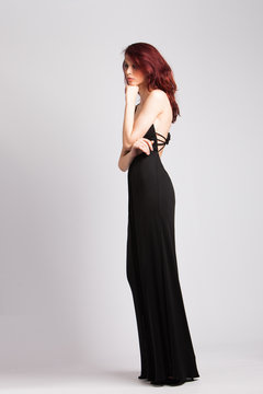 red-haired girl in long black evening dress