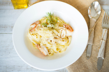 Spaghetti with tomato paste, hot Chili peppers and olive oil. On rustic background. Top view