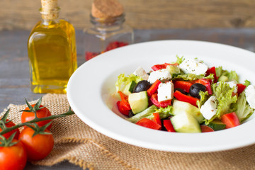 Greek salad with fresh vegetables, feta cheese and black olives. Top view