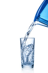 Pouring water from filter mug into glass on white background