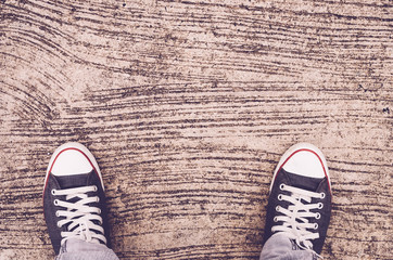 Top view of shoes and blue jean on street, selfie.