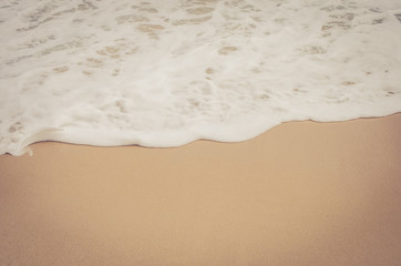 Close up tropical beach with smooth wave and sand texture background.