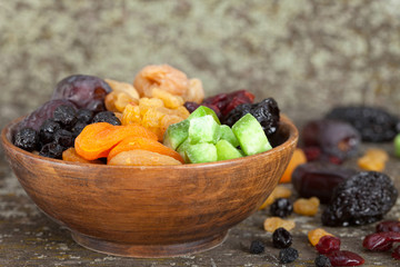 Sweet dried fruit in wooden bowl