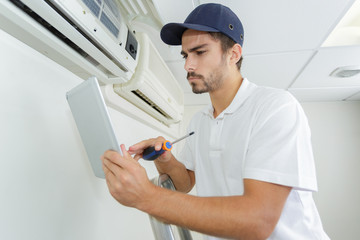 young contractor working carefully and seriously at clients office