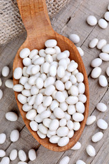 Wooden spoon with white beans