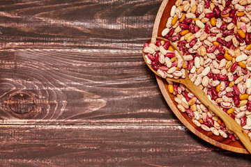 Bowl of haricot beans on the wooden table. Rustic style. Top view. Copy space