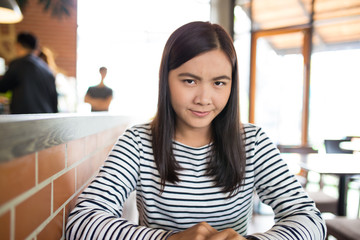 Angry woman sitting in the cafe