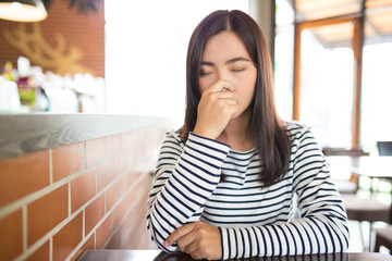 Woman has sneezing in cafe