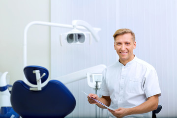 Naklejka na ściany i meble Dentist with image in the hands of workplace hospital his office.