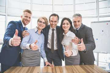 Happy working team is standing at the office