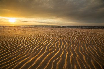 Fototapeta na wymiar Sand dunes against the sunset light on the beach in northern Poland