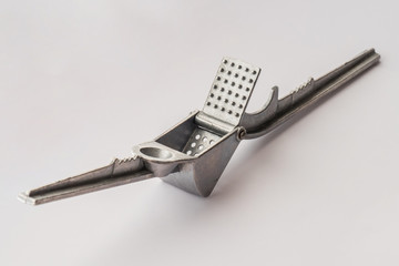 Press for garlic, close up / Garlic press isolated on white background