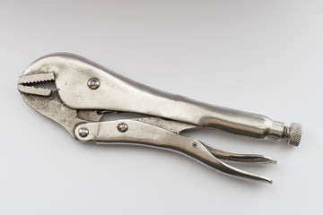 Locking pliers, close up / Locking pliers with closed jaws isolated on white background 