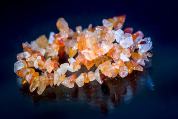bracelet mix precious stones and beads isolated on dark blue.