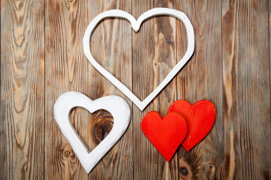 Holidays gift and heart on wooden rustic background. Valentines day
