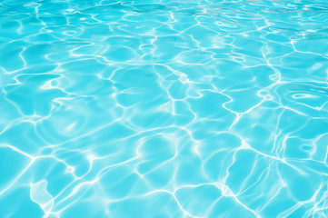 Fototapeta na wymiar Ripple water with sun reflection in swimming pool