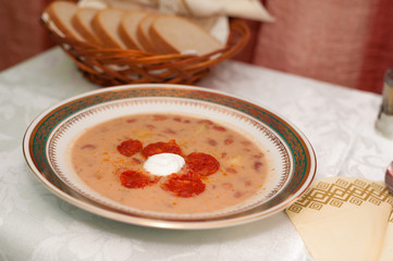 Bean soup with cream sausage on a plate